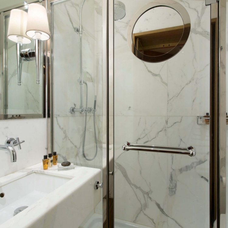 Marble bathroom with luxurious shower. Guest amenities.